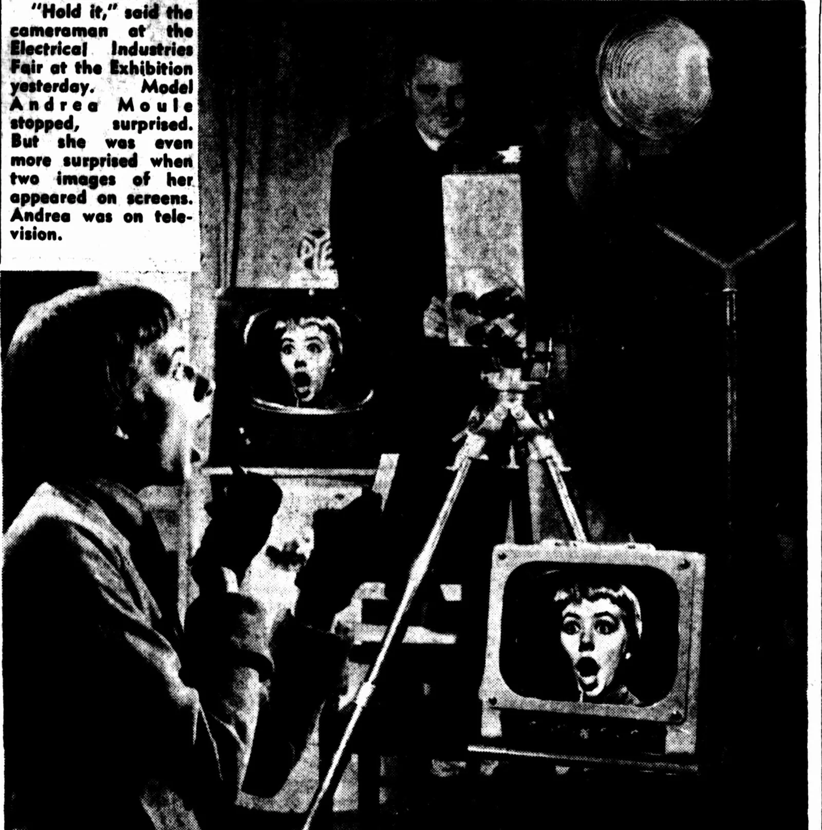 A newspaper photograph: a young woman with a fringe, mouth open in surprise, faces a television camera on a tripod while her own startled face appears on two television screens beside it; a cameraman stands behind.